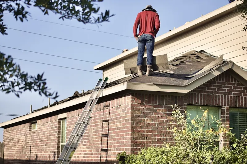 Professional roofer working on a residential roof in South Covington